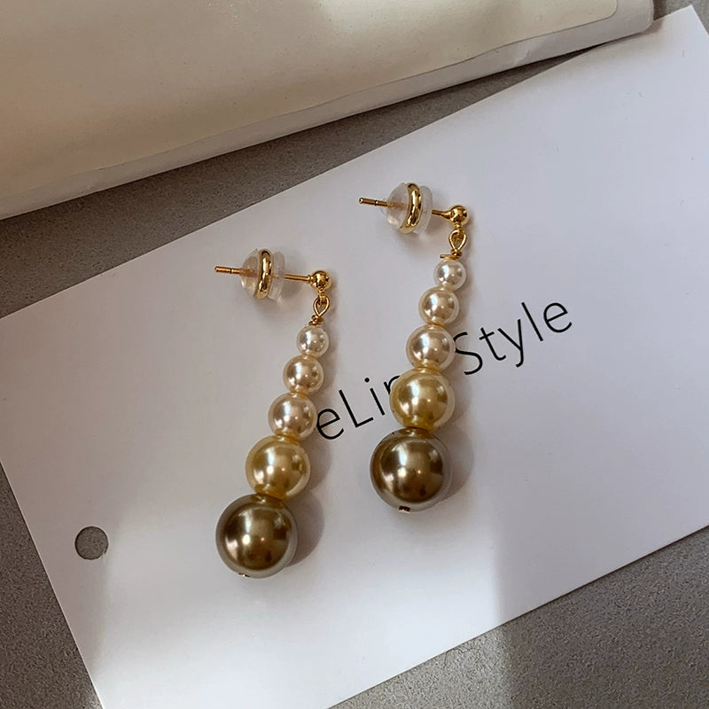 Gold size gradual change pearl stud earrings women 2025 new light luxury niche show face small long high-end earrings