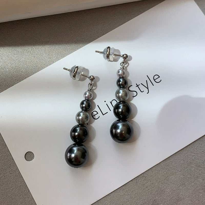 Gold size gradual change pearl stud earrings women 2025 new light luxury niche show face small long high-end earrings